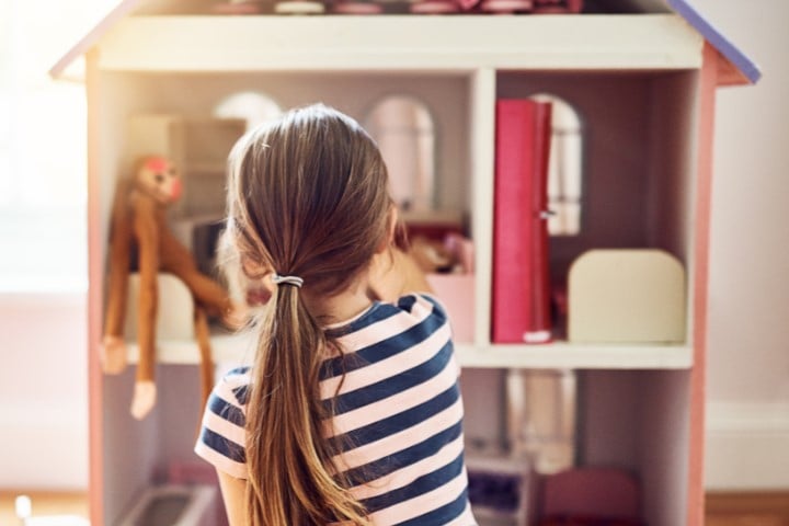 child with dollhouse