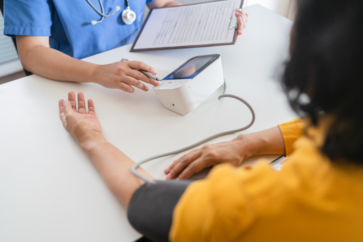 woman getting her blood pressure checked