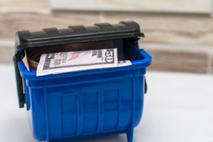 50 dollar bill in tiny dumpster