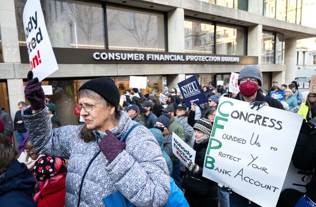 protestors marching in front of the consumer financial protection bureau building