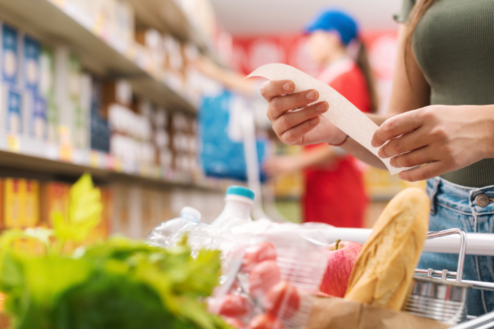 woman with paper in hand at grocery store