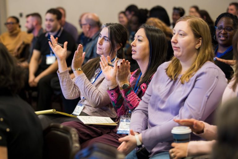 woman at conference applauding