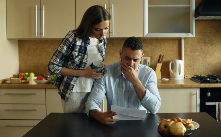 a couple looking with concern at a bill