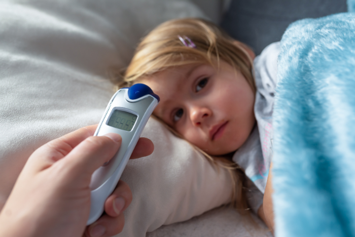 Child having her temperature taken