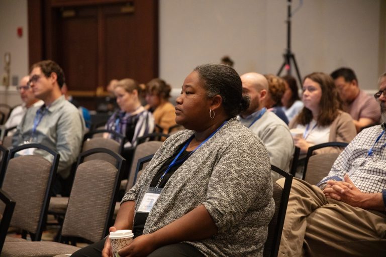 Conference attendees sitting in the audience of a session