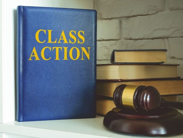 Folder that says "class action" next to a stack of books and gavel