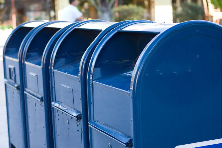 Row of blue USPS mailboxes